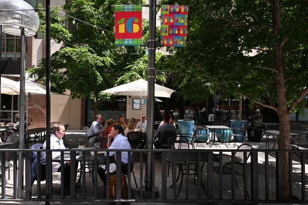 People eat lunch on a patio on the 16th Street Mall in Denver on May 13, 2025. (Photo by Helen H. Richardson/The Denver Post)