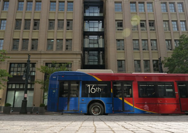 A 16th Street bus rolls past the site where the company Ibotta has signed a multi-year lease for 85,000 square feet of office space in the eight-story 16 Market Square building in downtown Denver, seen here on May 21, 2025. (Photo by RJ Sangosti/The Denver Post)